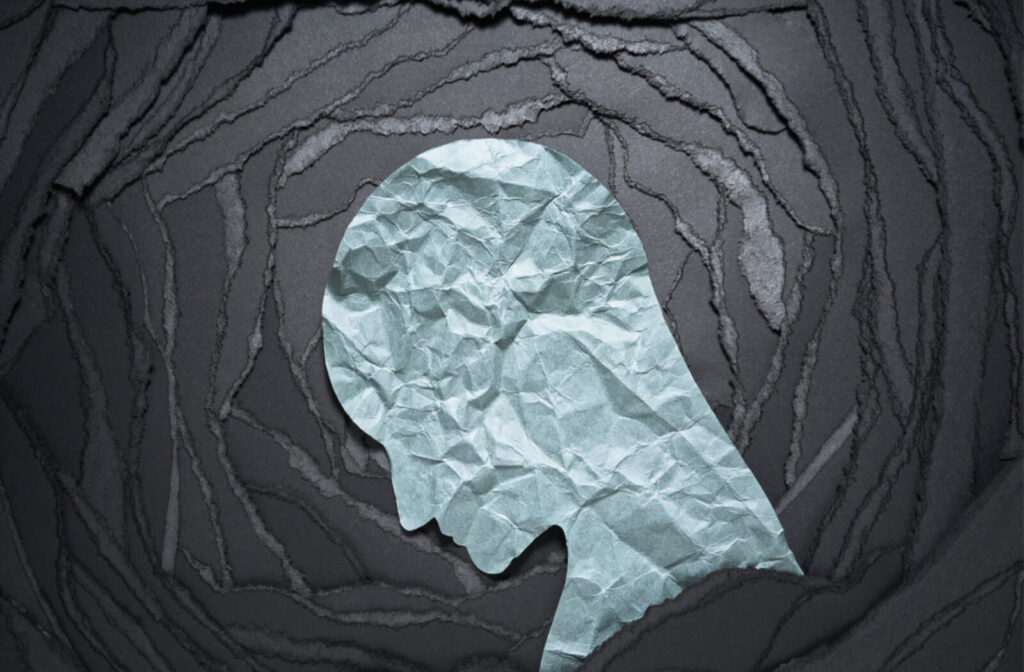 a paper cutout of a head looking sad 